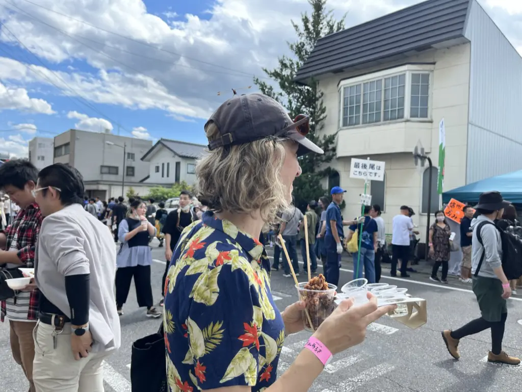 Vivian walking with sake and karaage